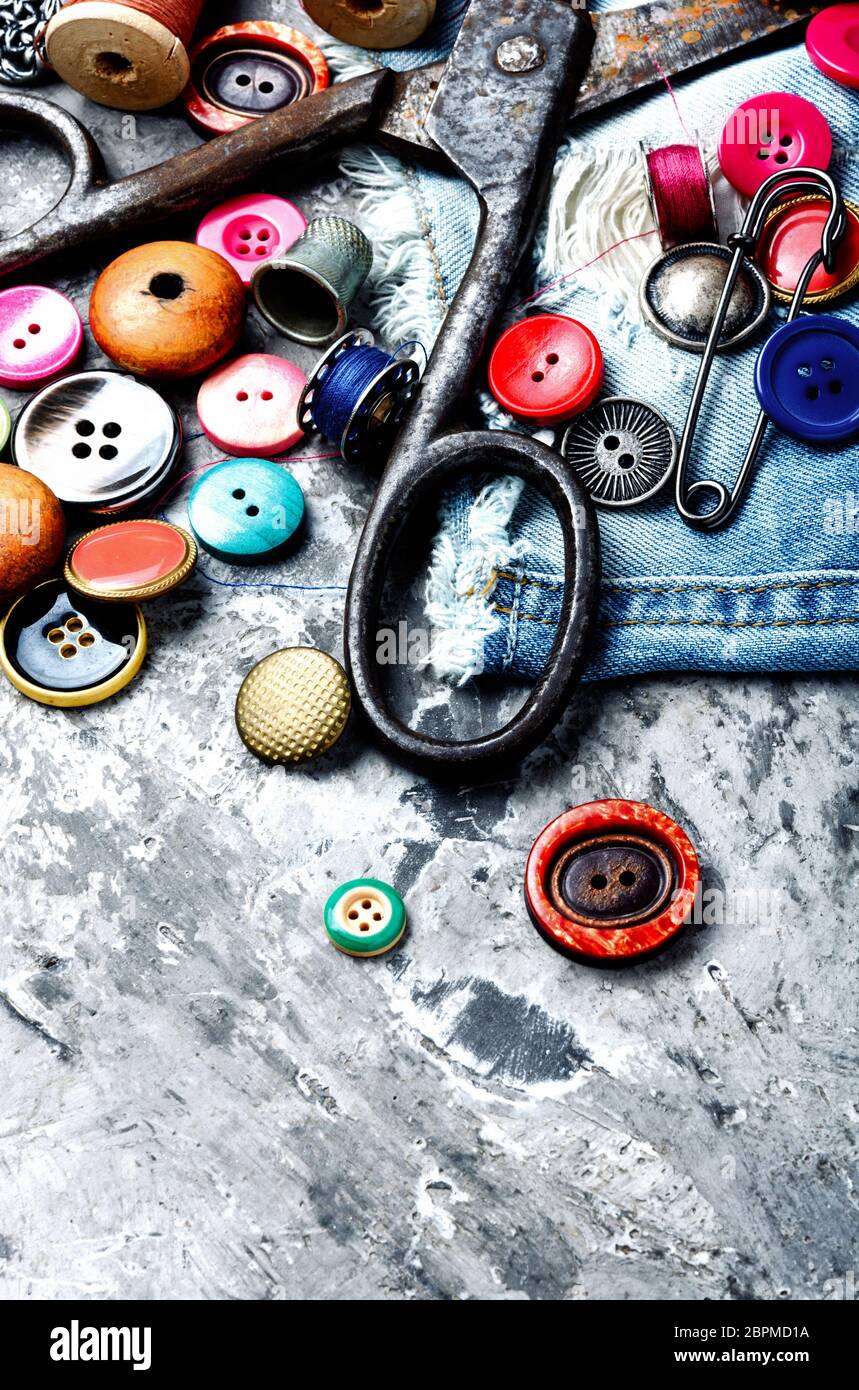 Composition with threads and sewing accessories.Sewing threads, fabric and buttons Stock Photo