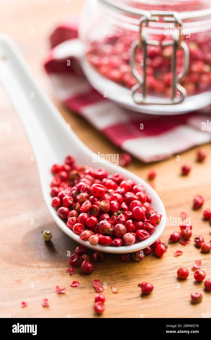 Dried pink peppercorn in spoon. Stock Photo