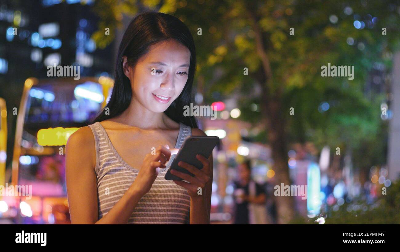 Woman use of smart phone in Hong Kong Stock Photo - Alamy