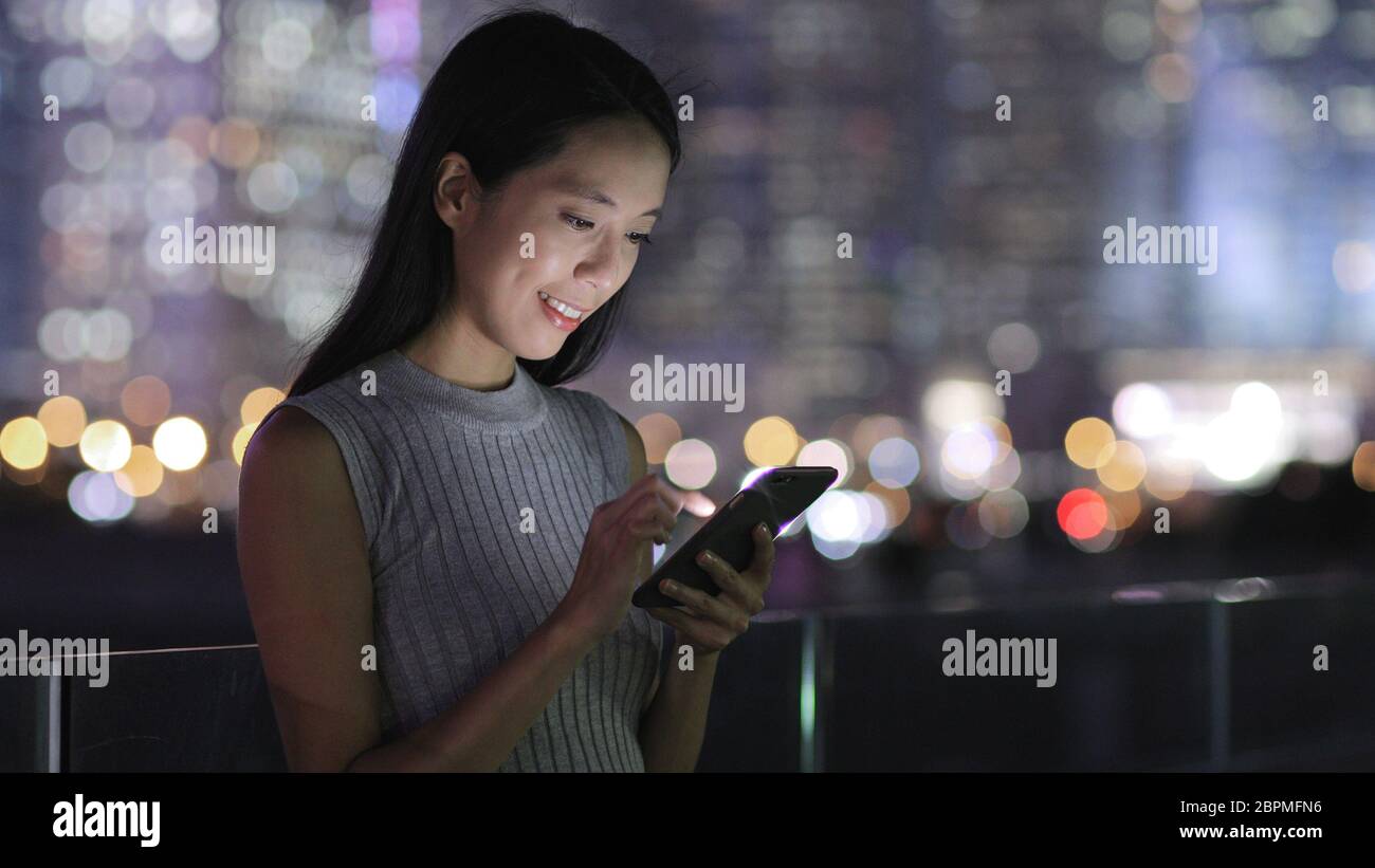 Woman use of mobile phone in Hong Kong city Stock Photo - Alamy
