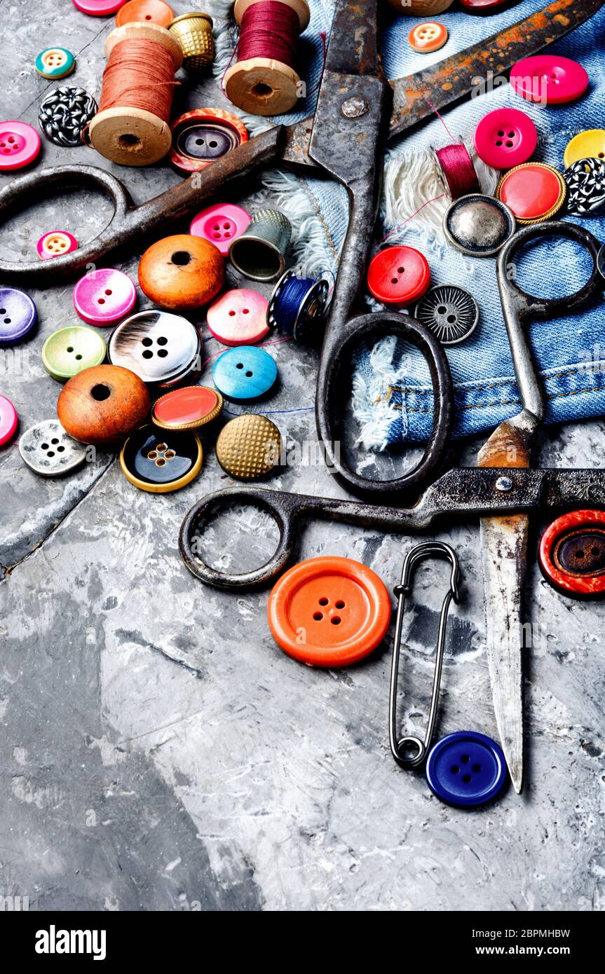 Composition with threads and sewing accessories.Sewing threads, fabric and buttons Stock Photo