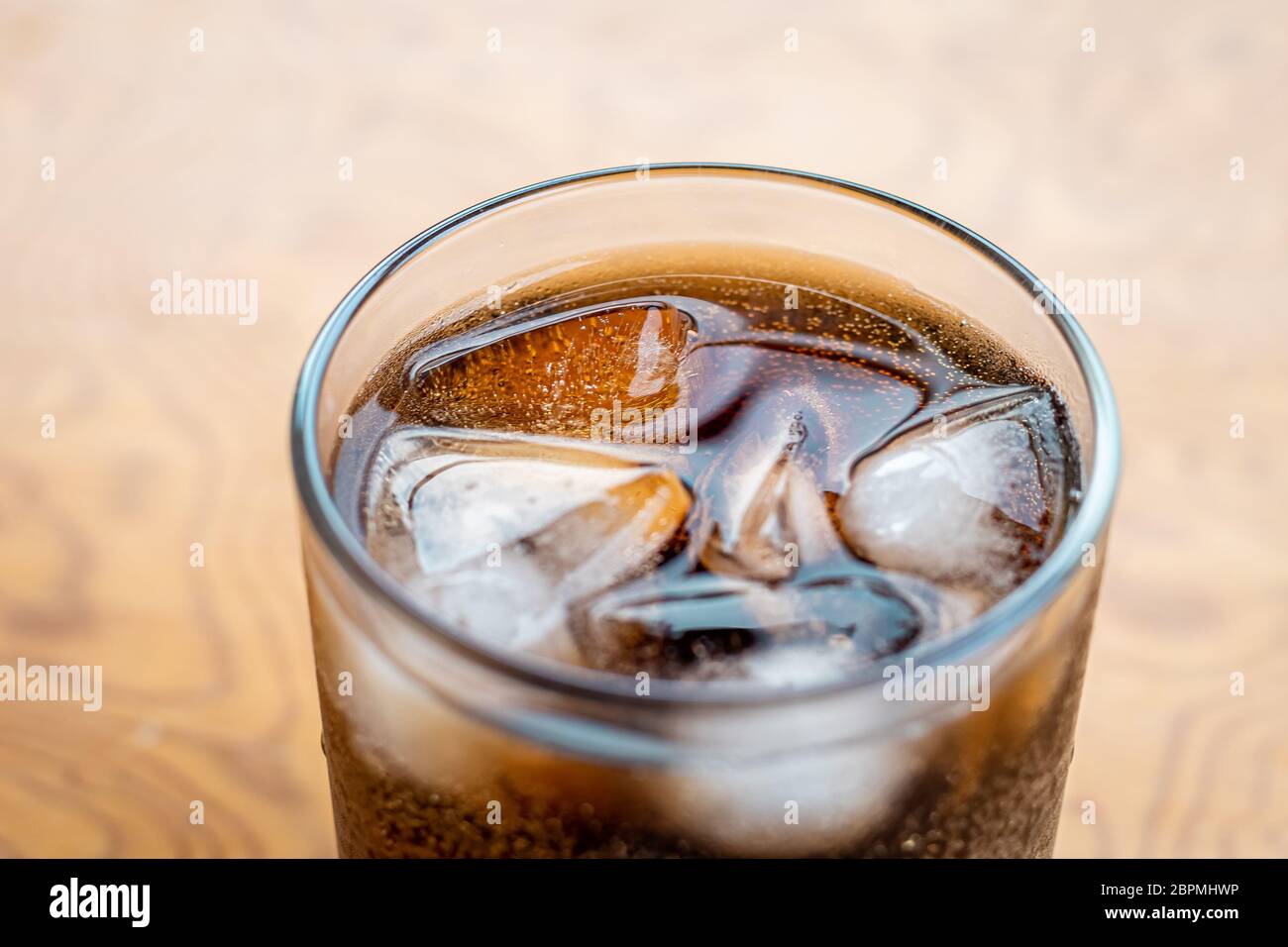 Close up Glass filled with carbonated cola soft drink with ice cubes. selective focus Stock Photo