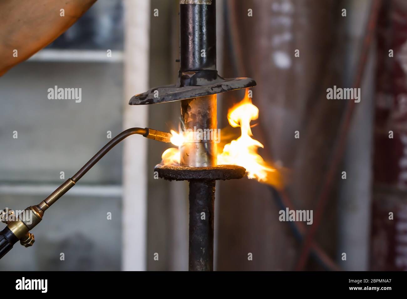 Welders were repairing cutting Shock absorbers of a car in workshop Stock Photo