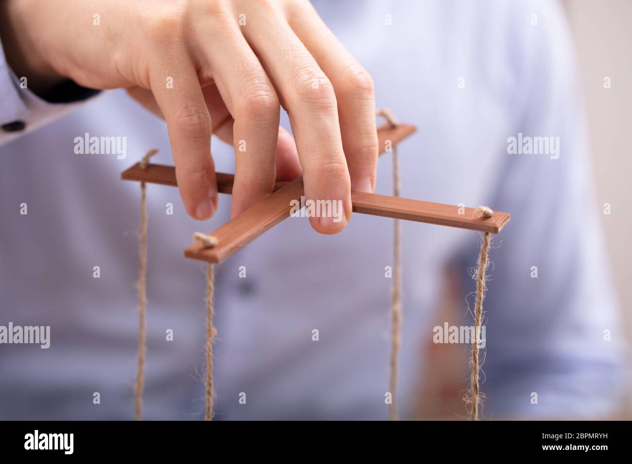Man holding puppet string close hi-res stock photography and images - Alamy