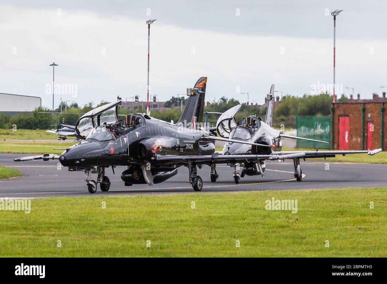 Pair of Hawk T2 training aircraft flown by the Royal Air Force seen taxiing to the runway at Liverpool airport in September 2015. Stock Photo