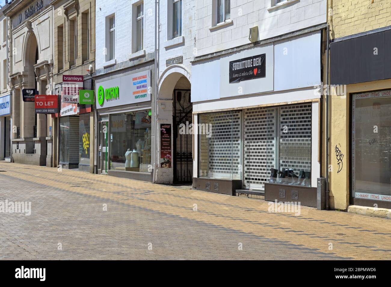 Closed shops on deserted New Street during the Coronavirus pandemic, Huddersfield, West Yorkshire, England, UK. Stock Photo