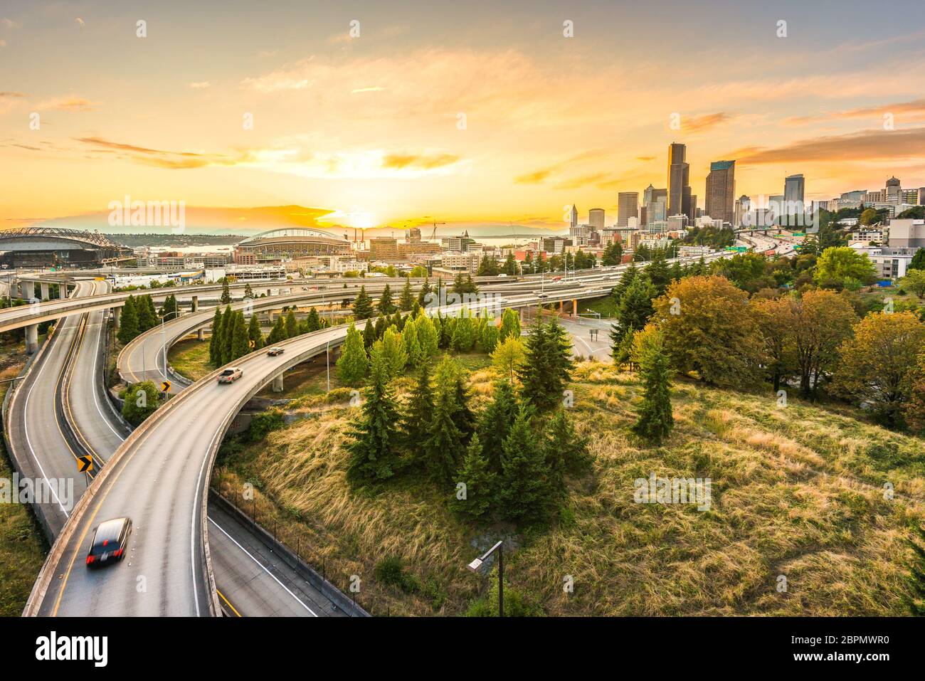 Seattle skylines and Interstate freeways converge with Elliott Bay and the waterfront background of in sunset time, Seattle, Washington State, USA.. Stock Photo