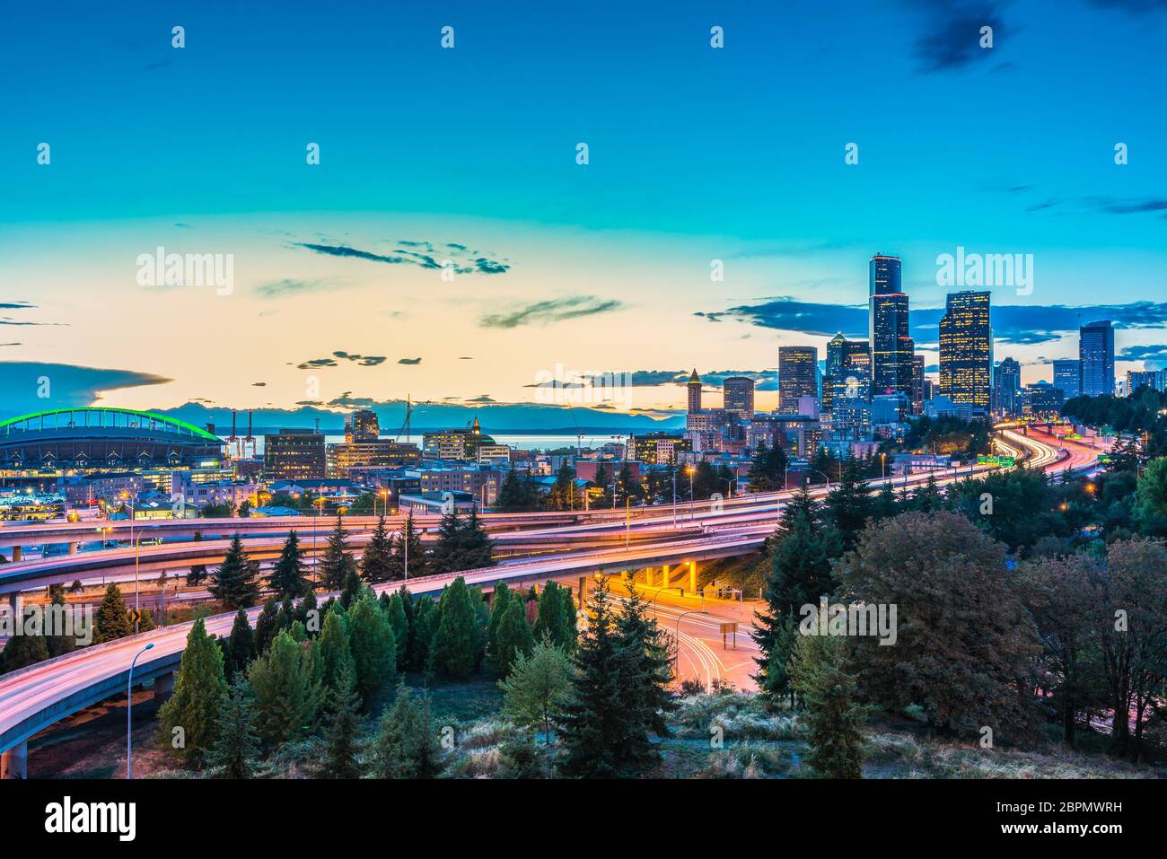 Seattle skylines and Interstate freeways converge with Elliott Bay and the waterfront background of in sunset time, Seattle, Washington State, USA.. Stock Photo