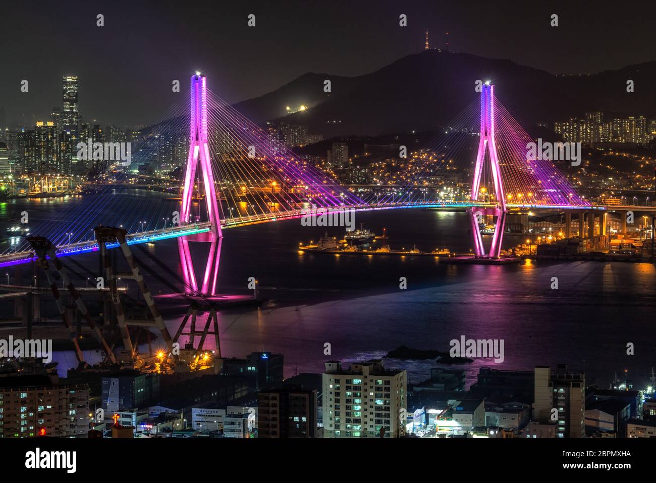 Busan harbor bridge is one of famous bridges in south korea. Connecting Yeongdo and Nam district, the bridge lits up at night in different colors. Tak Stock Photo