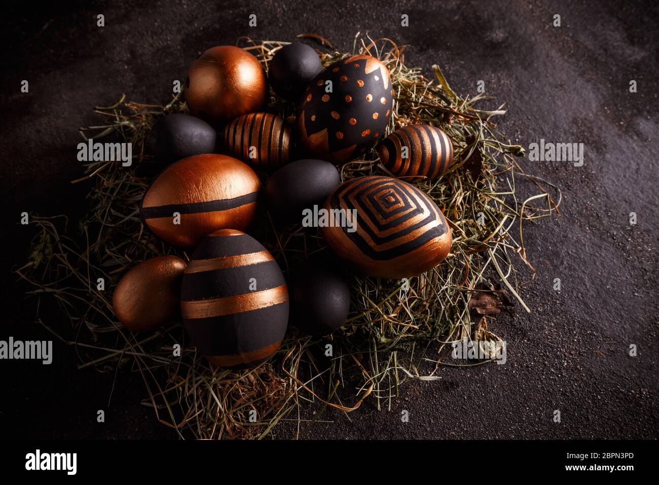 Easter golden and black eggs with geometric pattern on dark background Stock Photo