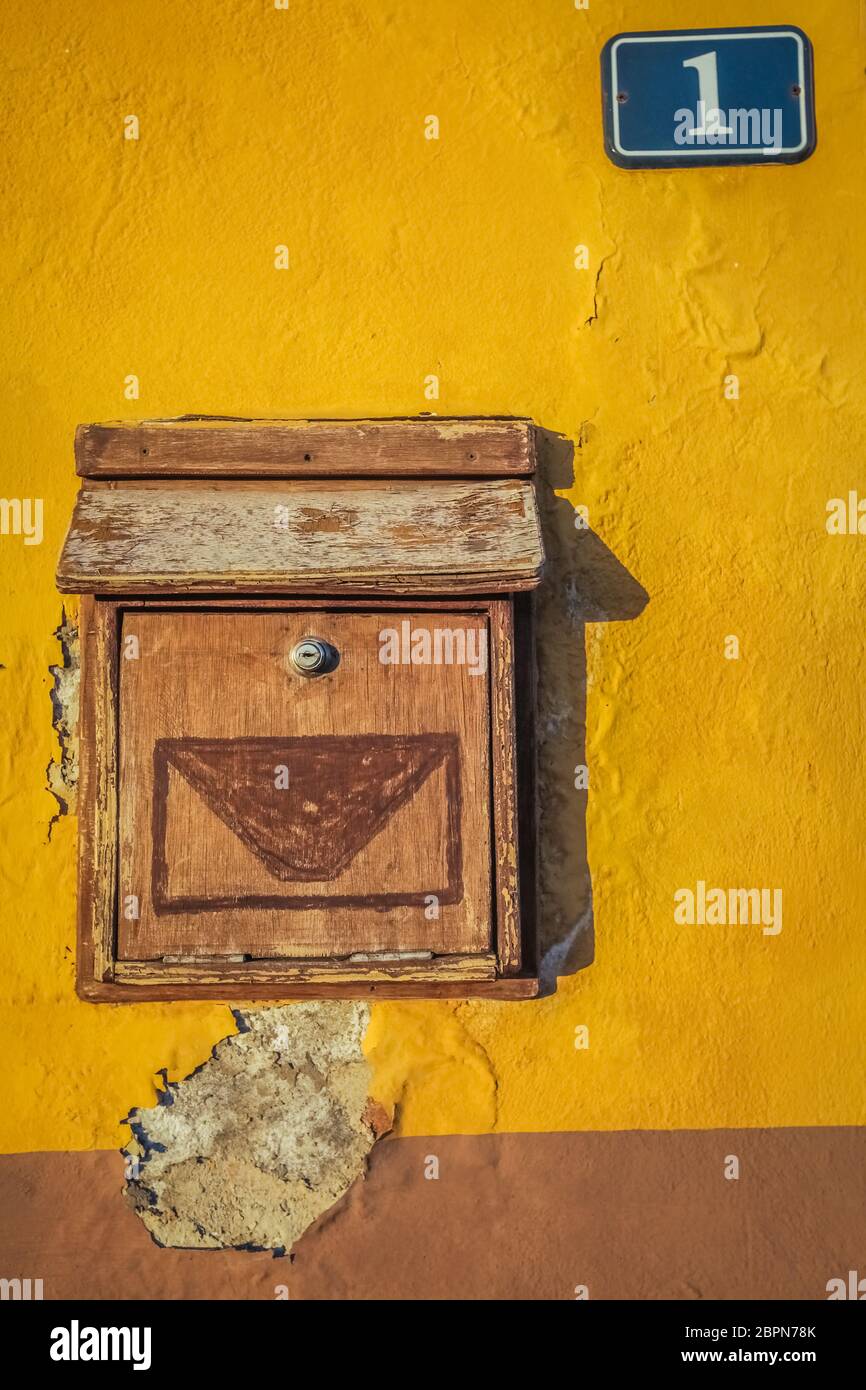 Old wooden letterbox on a yellow wall of a spanish home Stock Photo Alamy