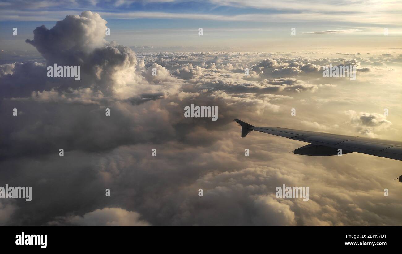 Airplane wing view out of the window on the cloudy sky Stock Photo - Alamy