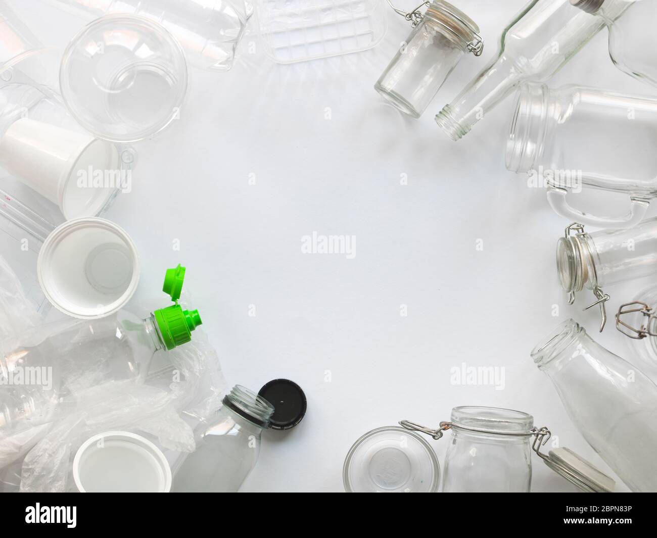 many different empty glass and plastic bottles lying on a white background Stock Photo
