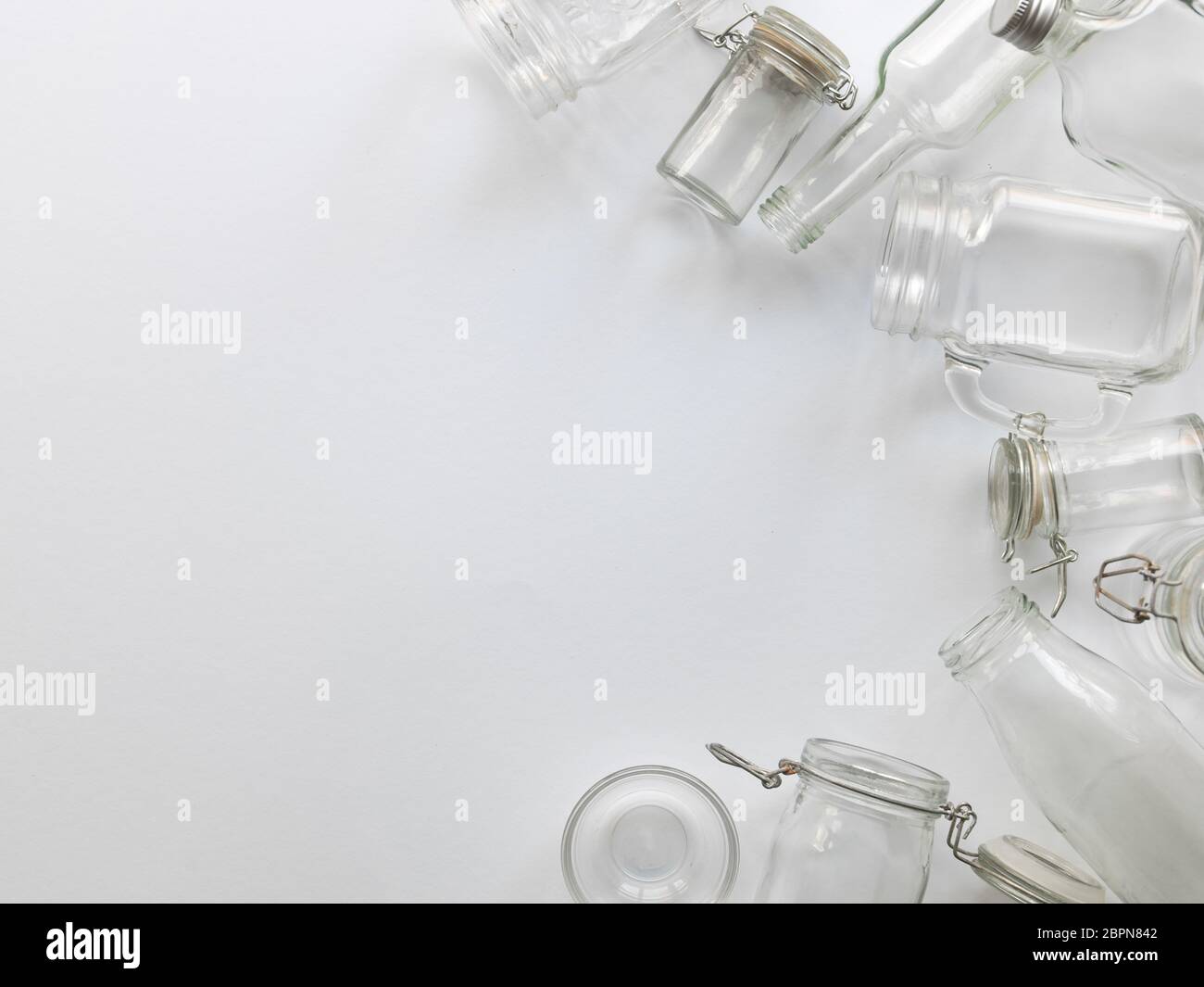 many different empty glass bottles lying on a white background Stock Photo