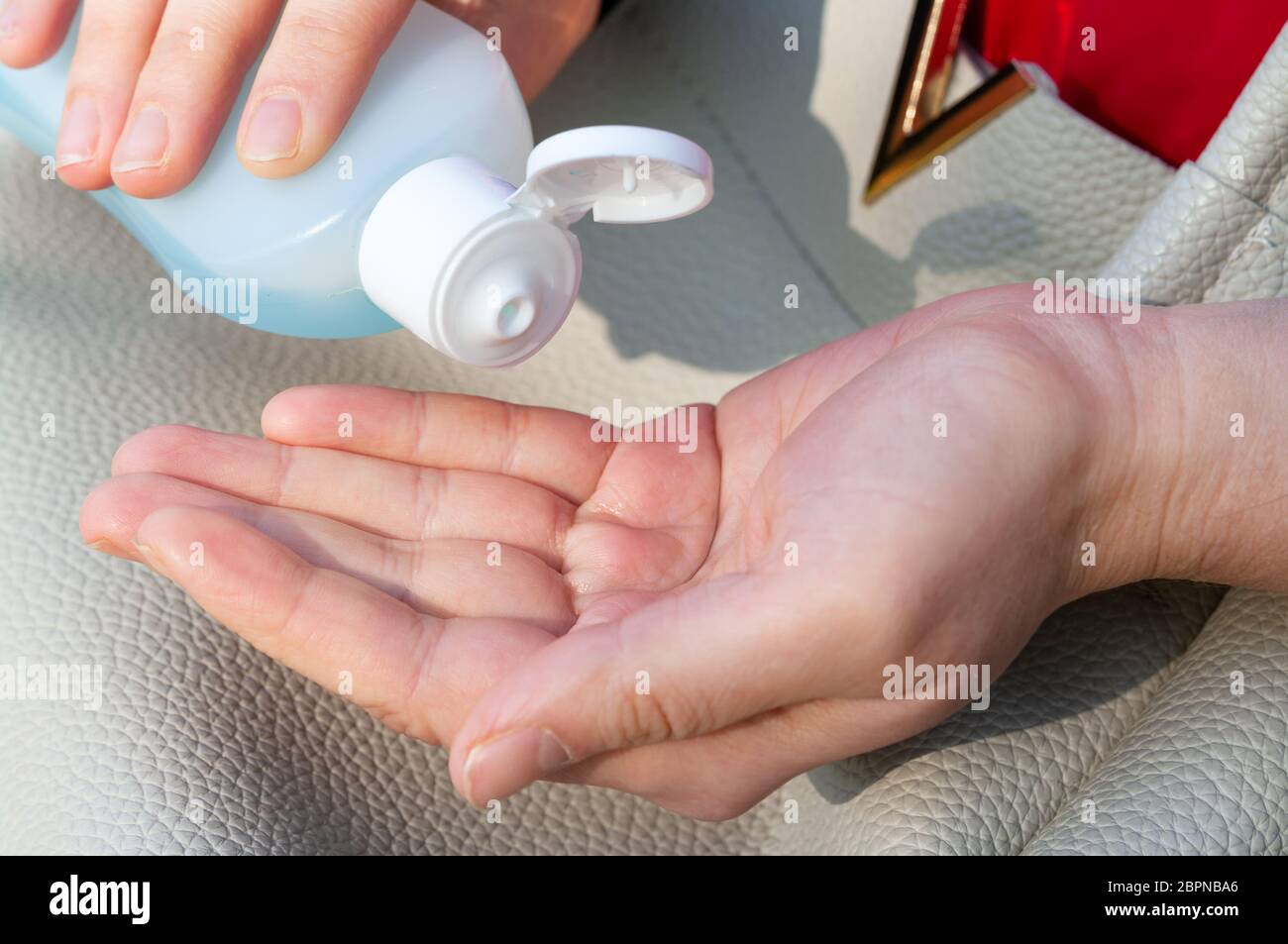 Women's hands using wash hand sanitizer gel. Stock Photo