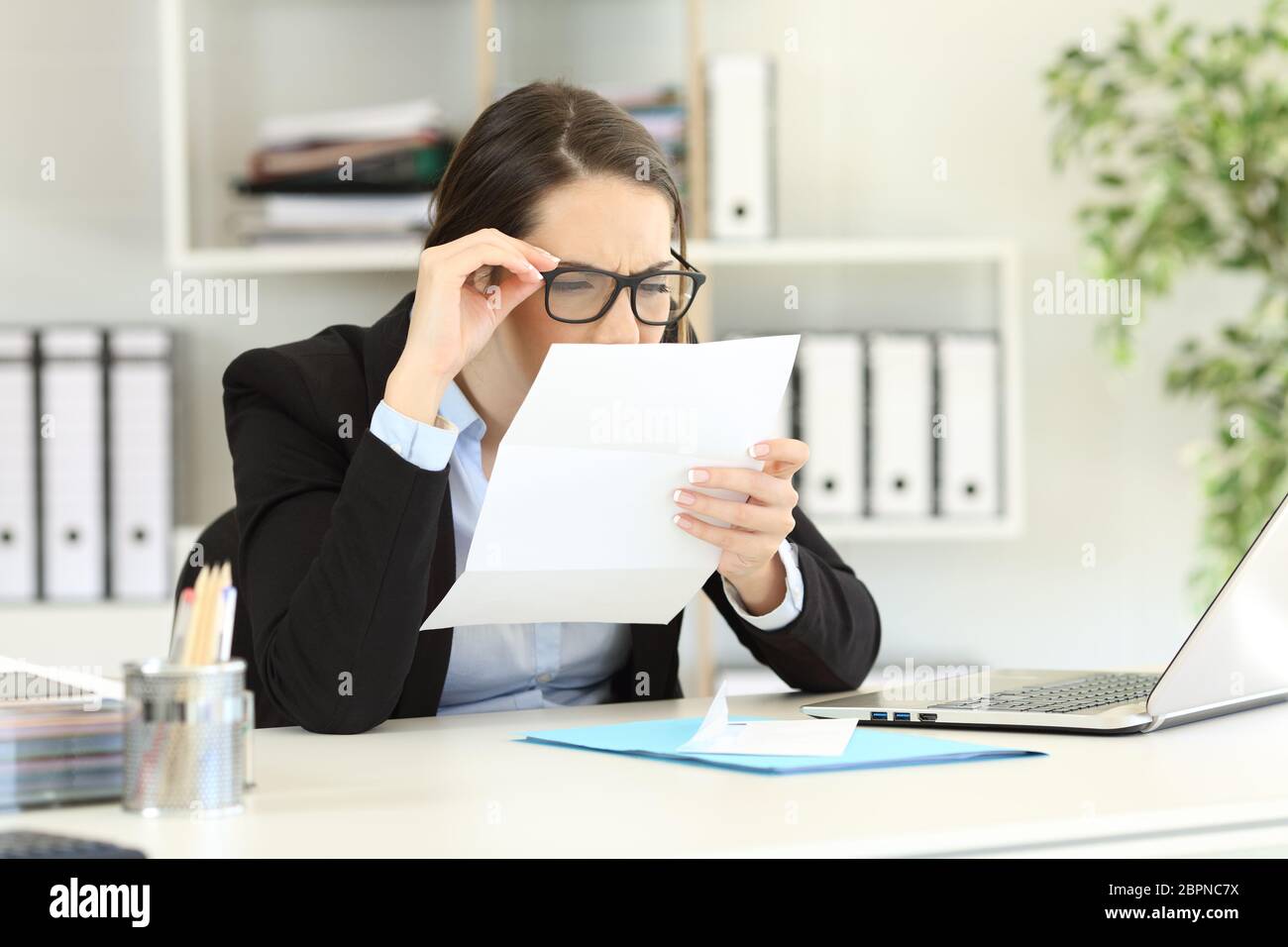 Office employee wearing eyeglasses with bad graduation having eyesight ...