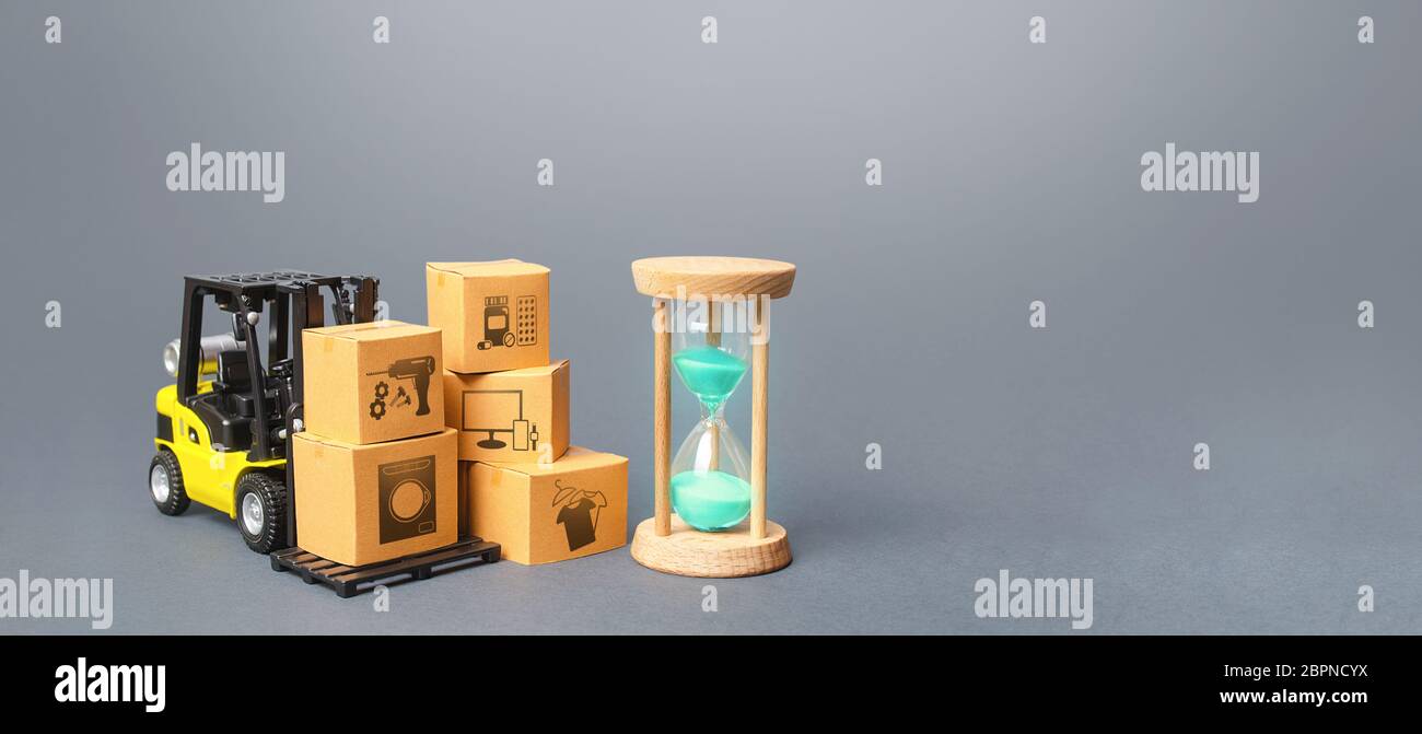 Forklift with boxes and hourglass. Fast delivery times for goods and products, transport costs and delays at customs. Delivery, warehousing services. Stock Photo