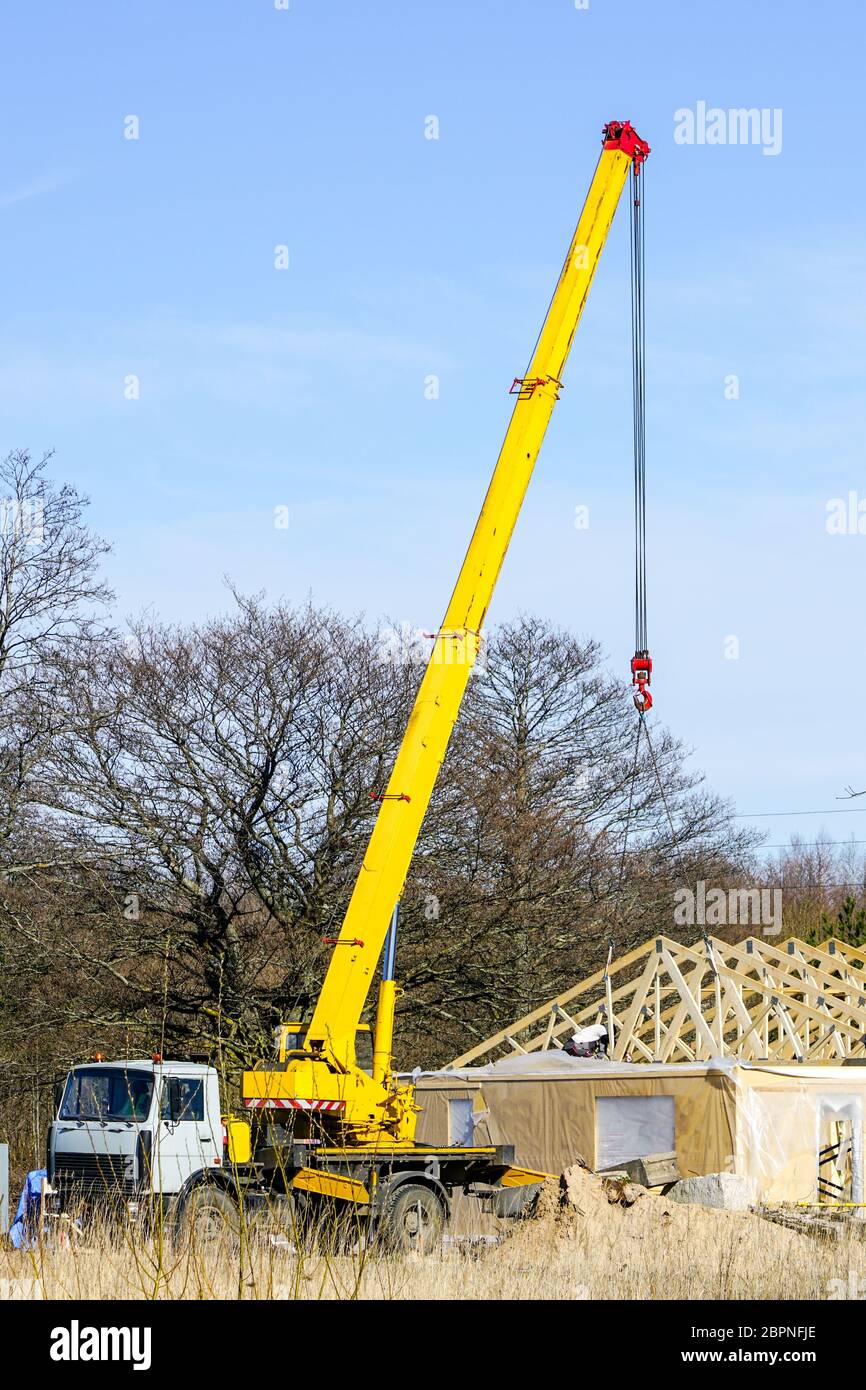 Truck mounted crane with a telescoping boom at constructing a carcas of