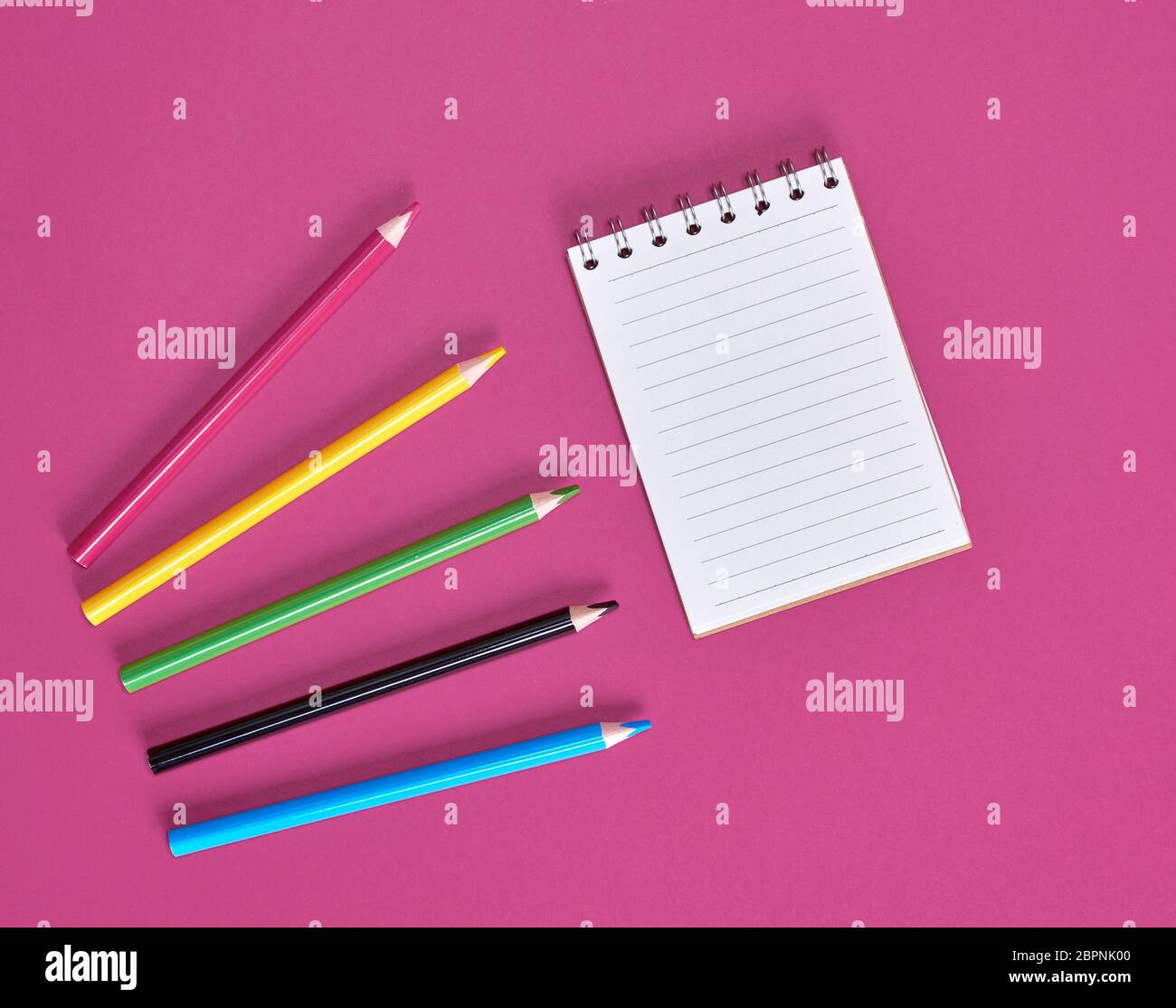 open notebook with empty white sheets and multicolored wooden pencils Stock Photo