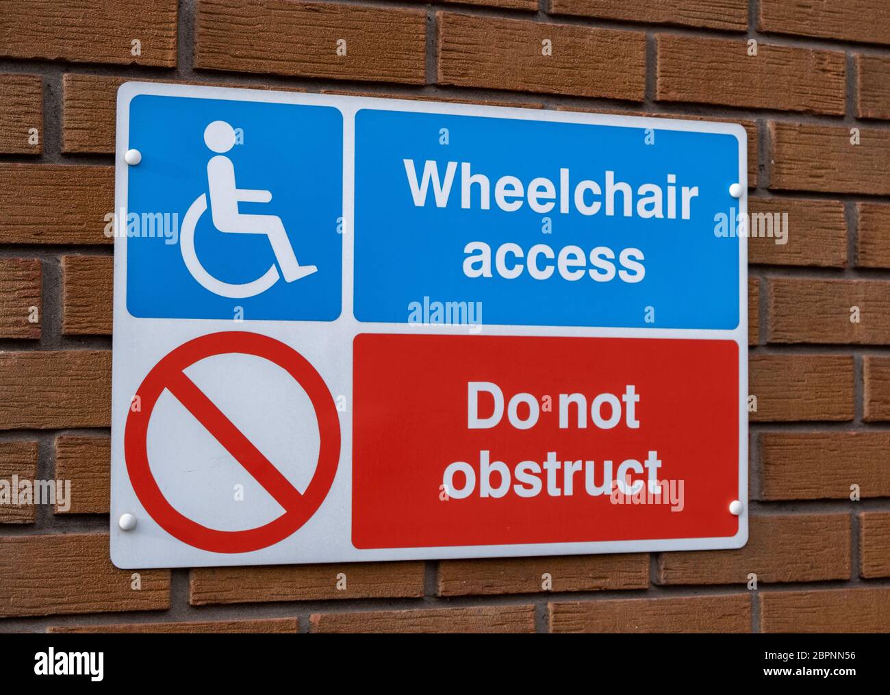 Wall mounted sign indicating wheelchair access and do not obstruct inBirkenhead Wirral January