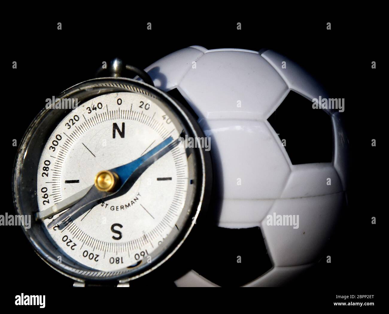 Soccer ball and compass, to show that football has to take a turn after this quarantine Stock