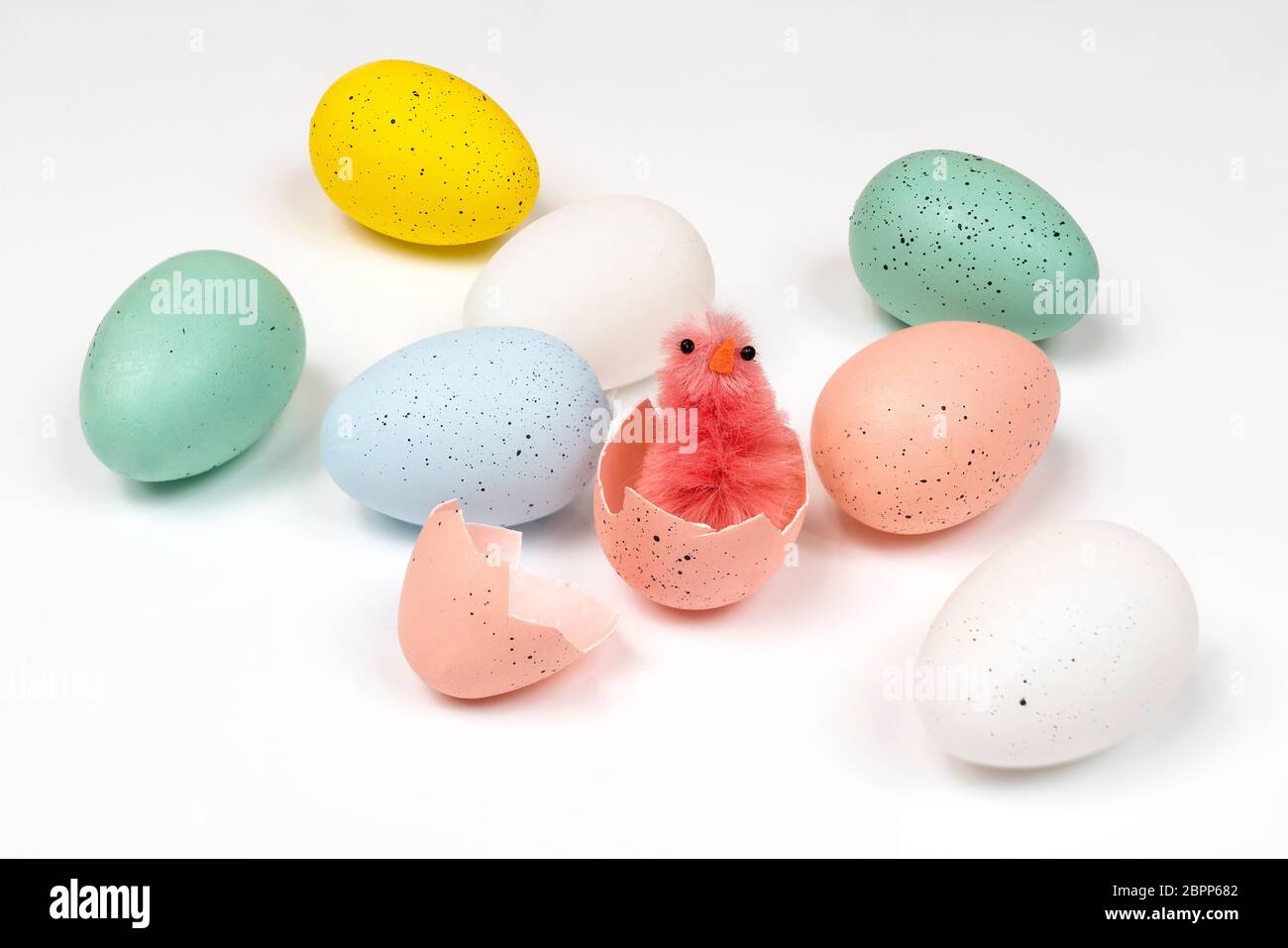 colored easter eggs with little chicks on a white surface Stock Photo