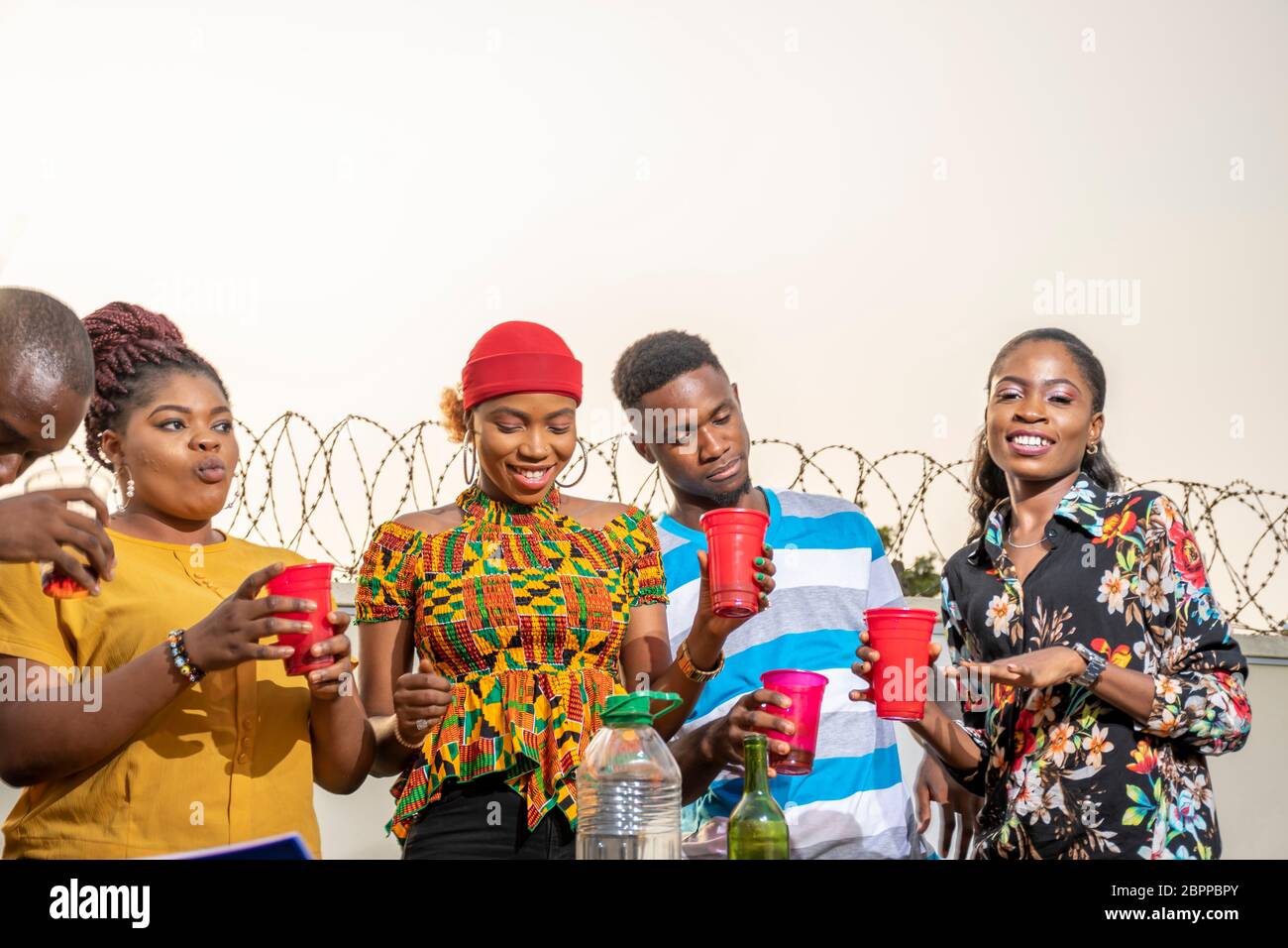 group of young black adults throwing a party, having a lot of fun, a