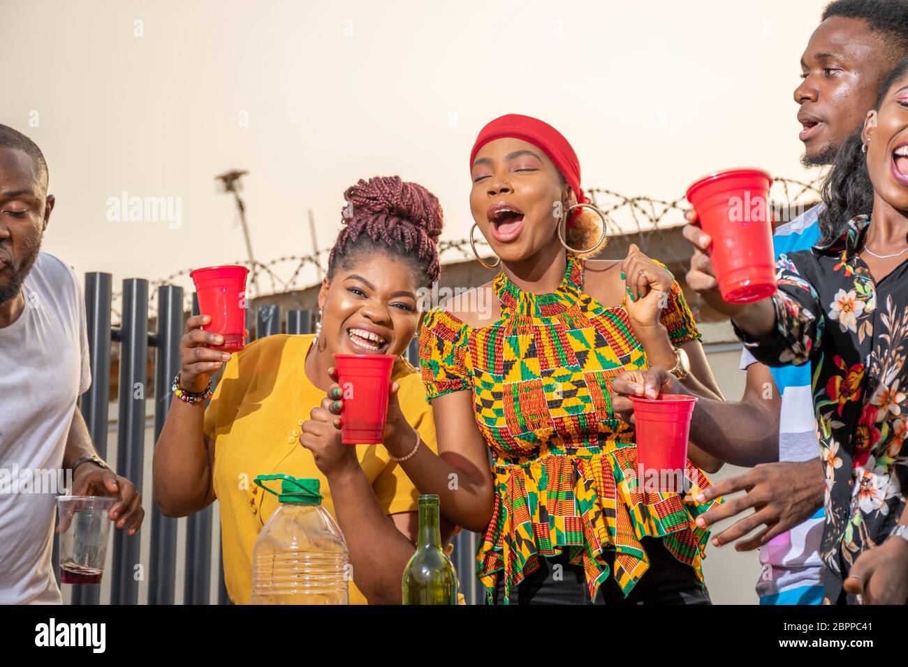 young african adults throwing a party, having fun and dancing Stock