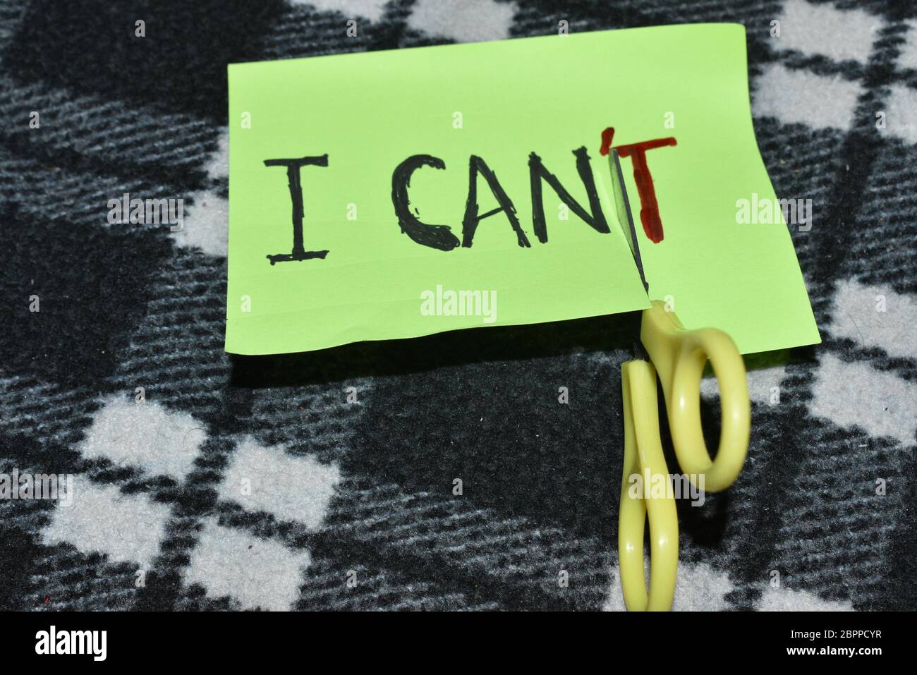 I can self motivation - cutting the letter 'T' of the written word I can't so it says I can, goal achievement, potential, overcoming Stock Photo