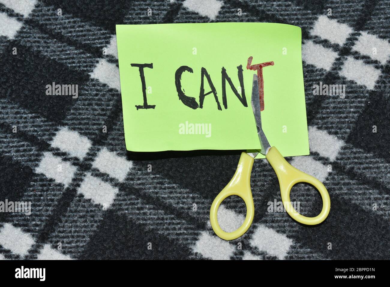 I can self motivation - cutting the letter 'T' of the written word I can't so it says I can, goal achievement, potential, overcoming Stock Photo