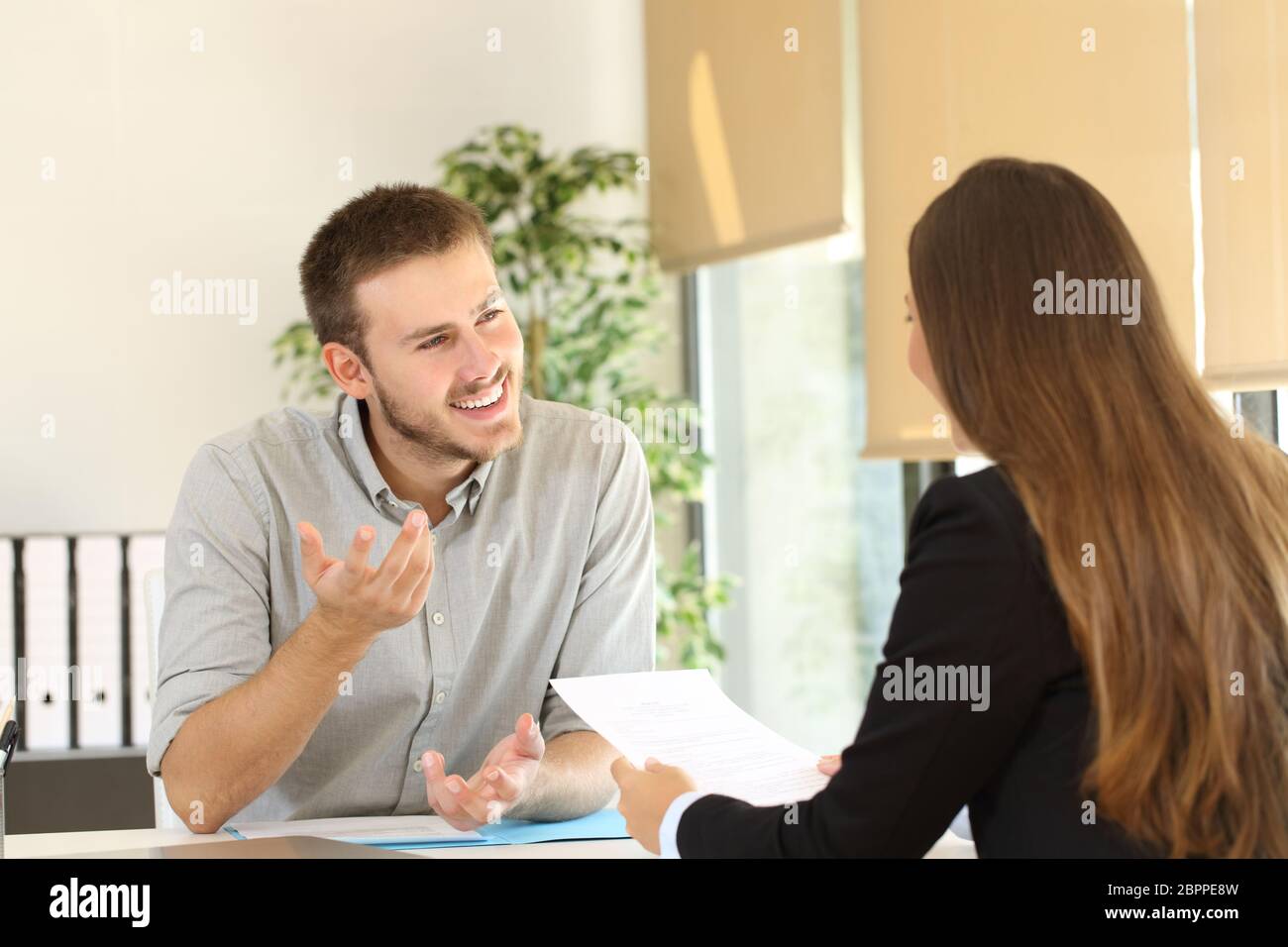 Confident man talking to his interviewer during a job interview Stock Photo