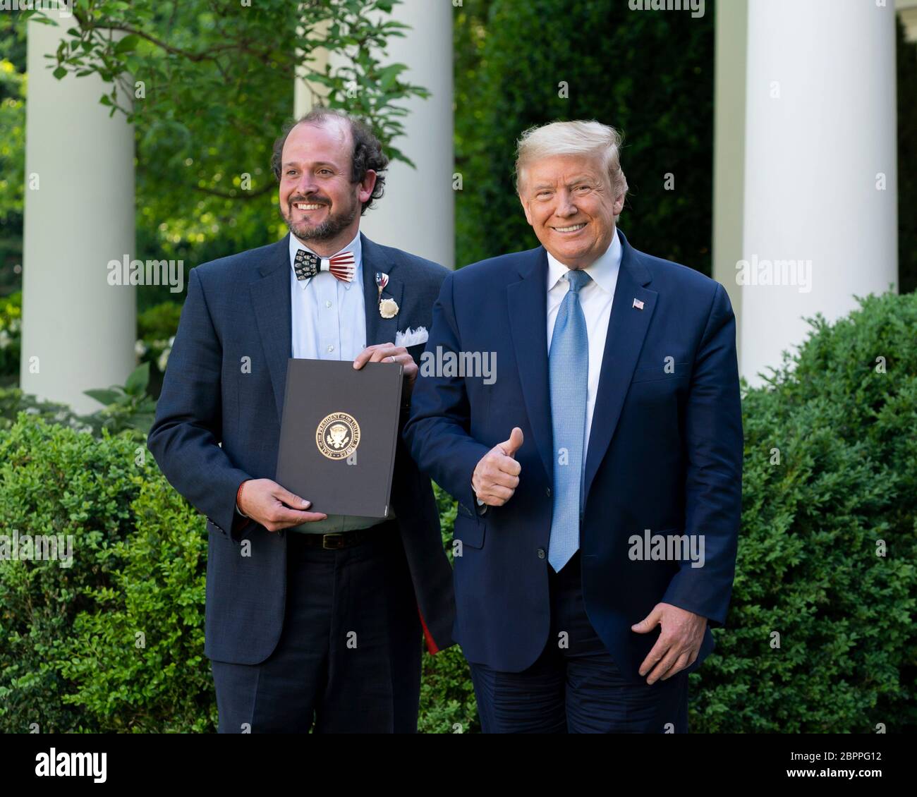 U.S. President Donald Trump presents Ben Ross, with a certificate of recognition during the Presidential Recognition Ceremony: Hard Work, Heroism, and Hope in the Rose Garden of the White House May 15, 2020 in Washington, D.C. The event honored front line workers battling the COVID-19, coronavirus pandemic. Stock Photo