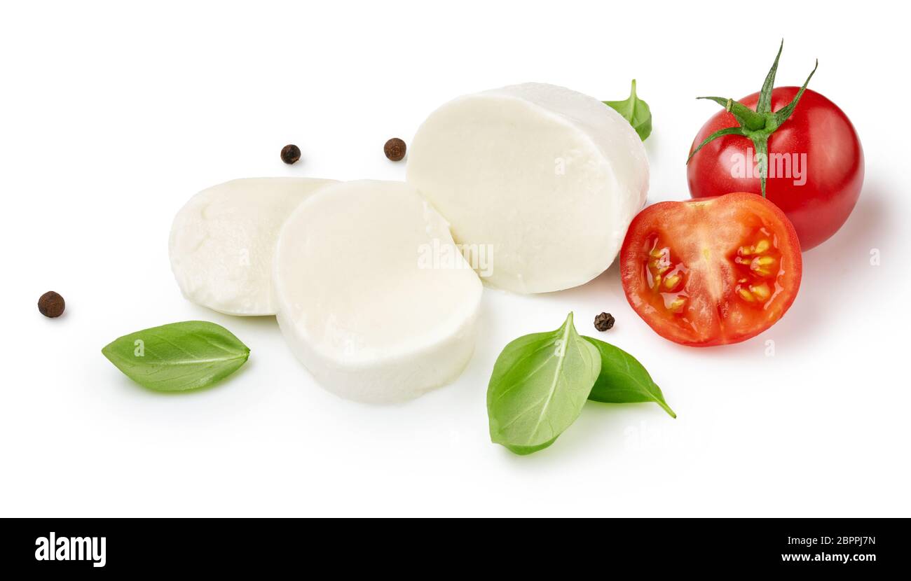 Pieces of mozzarella Buffalo cheese with tomatoes. Sliced cheese with black peppers and basil leaves isolated on white background. Stock Photo