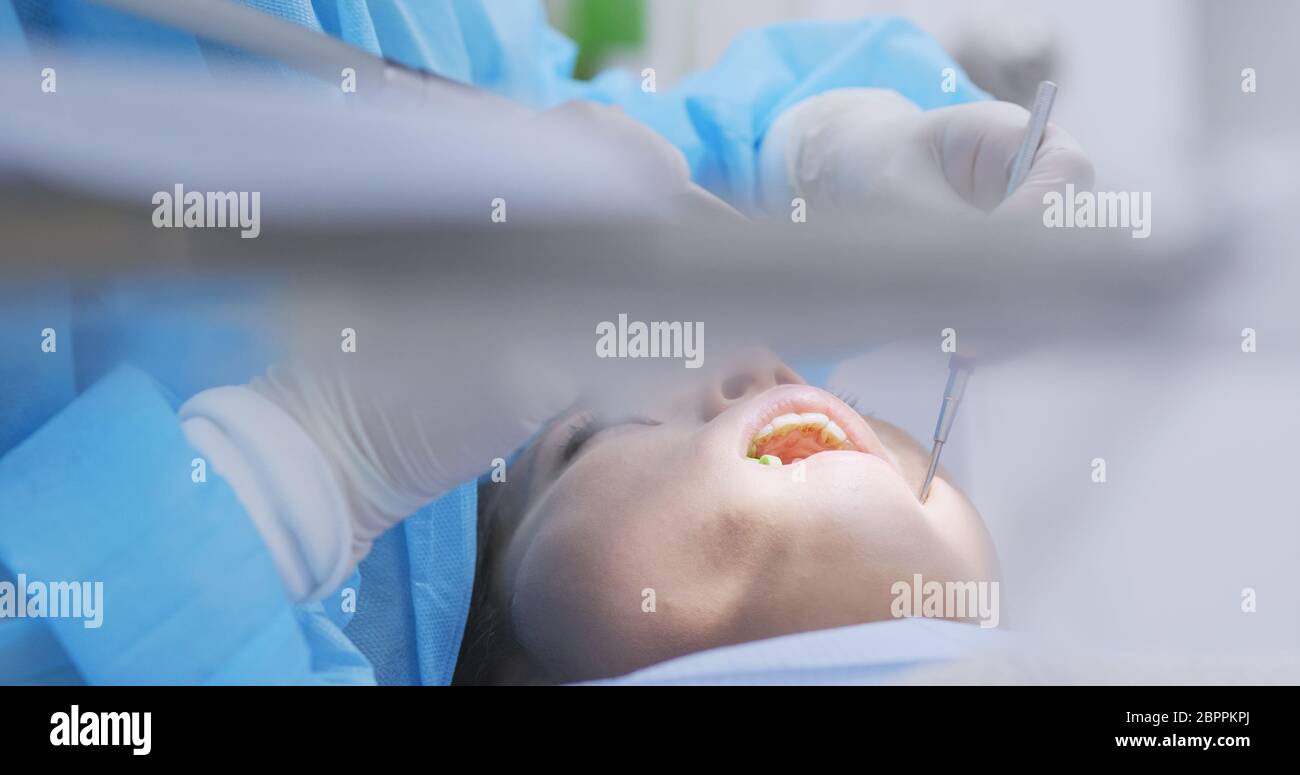 Woman undergo professional tooth whitening and ultrasound cleaning at dental clinic Stock Photo