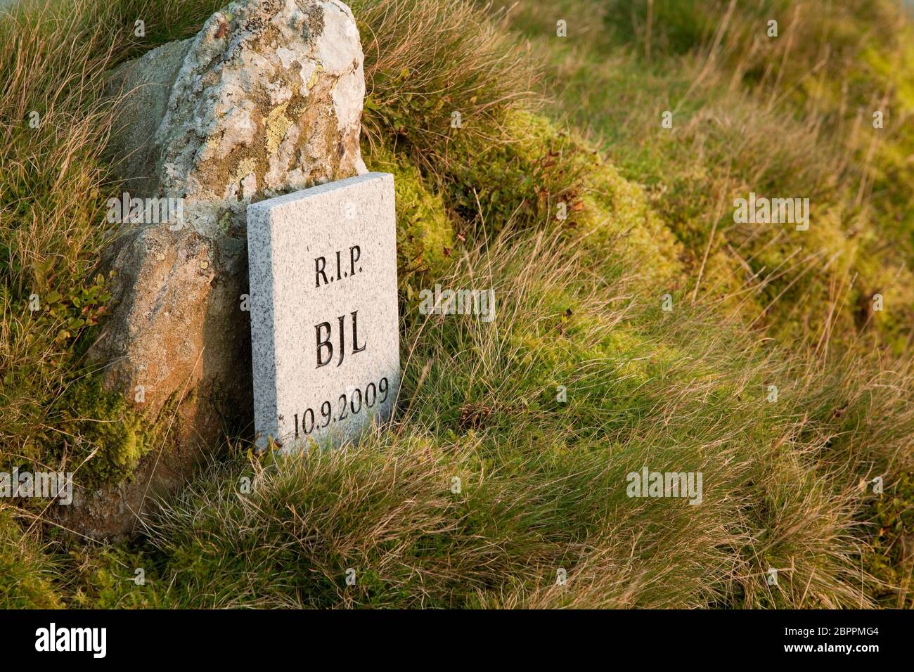A small marble gravestone near the summit of Haystacks in the English Lake District. Stock Photo
