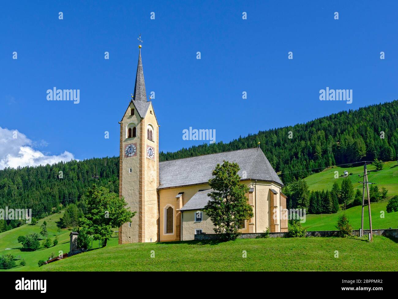 village church on a hill at Kartitsch in the Lesach valley of Eastern Tirol in sunshine, Austria Stock Photo