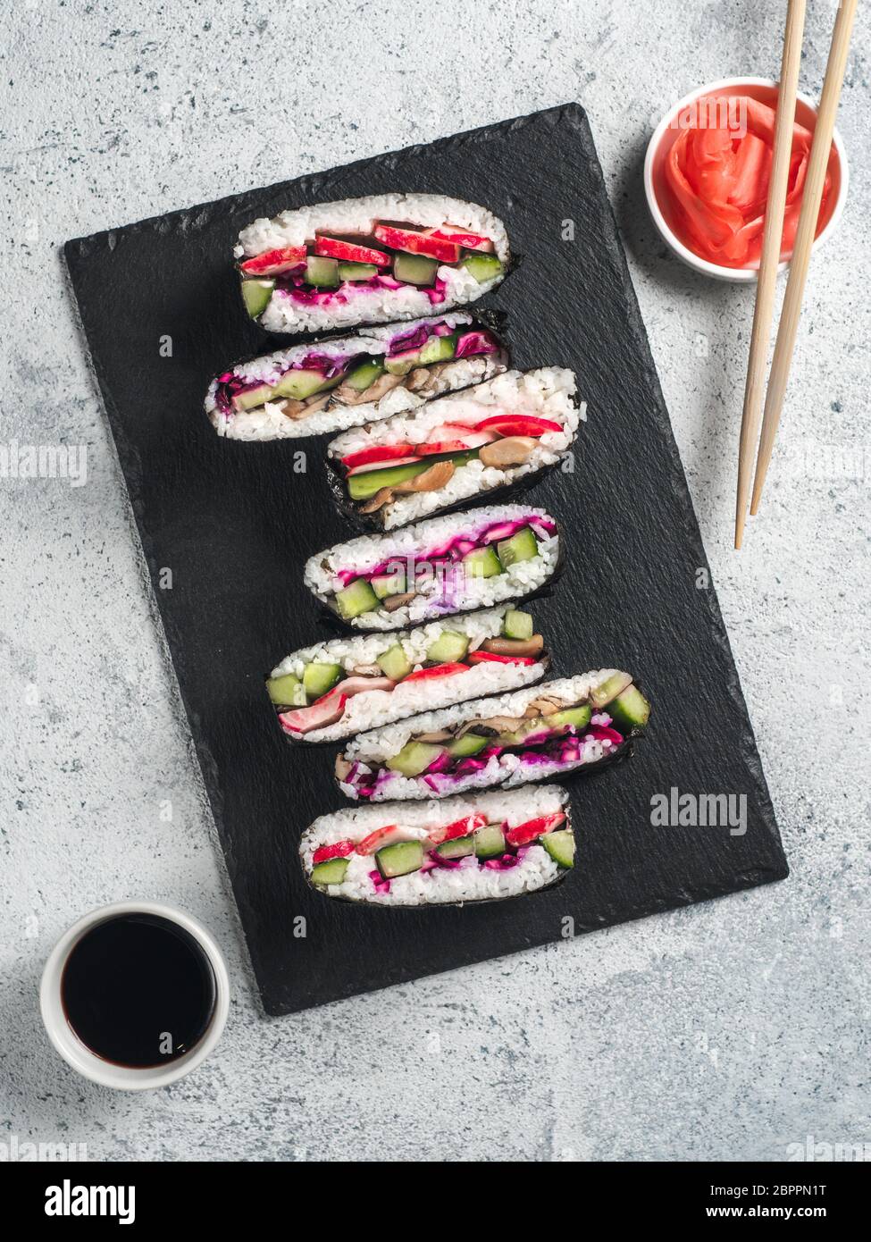 Vegan sushi sandwich onigirazu with mushrooms and vegetables. Healthy dinner recipe and idea. Colorful japan sandwich onigirazu with red cabbage,radis Stock Photo