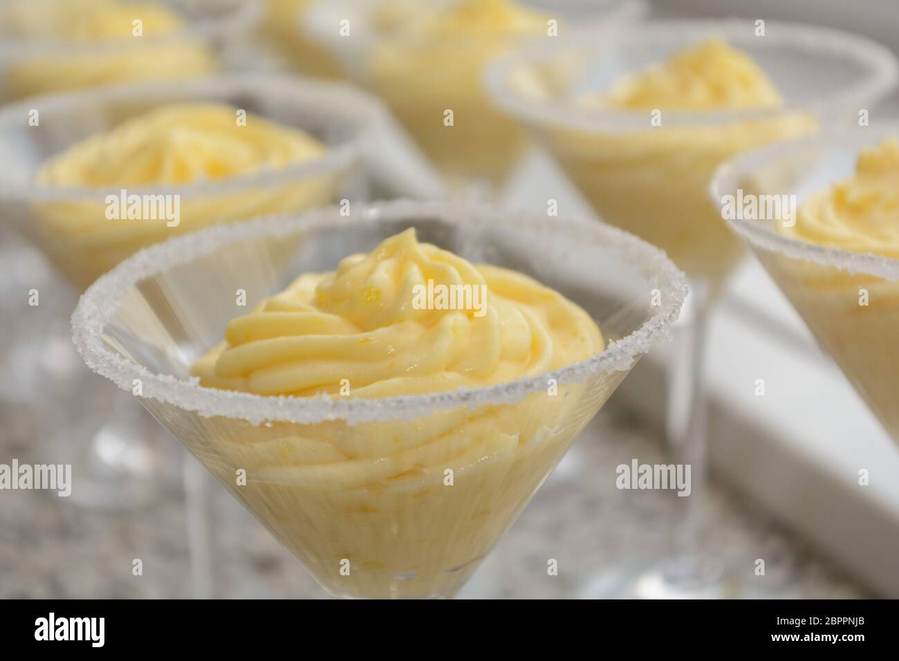 Delicious and tasty vanilla sauce in dessert glasses with sugar rim - depth of field Stock Photo