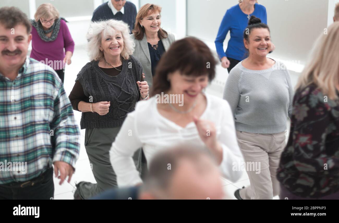 Successful business team running in the office hall Stock Photo - Alamy