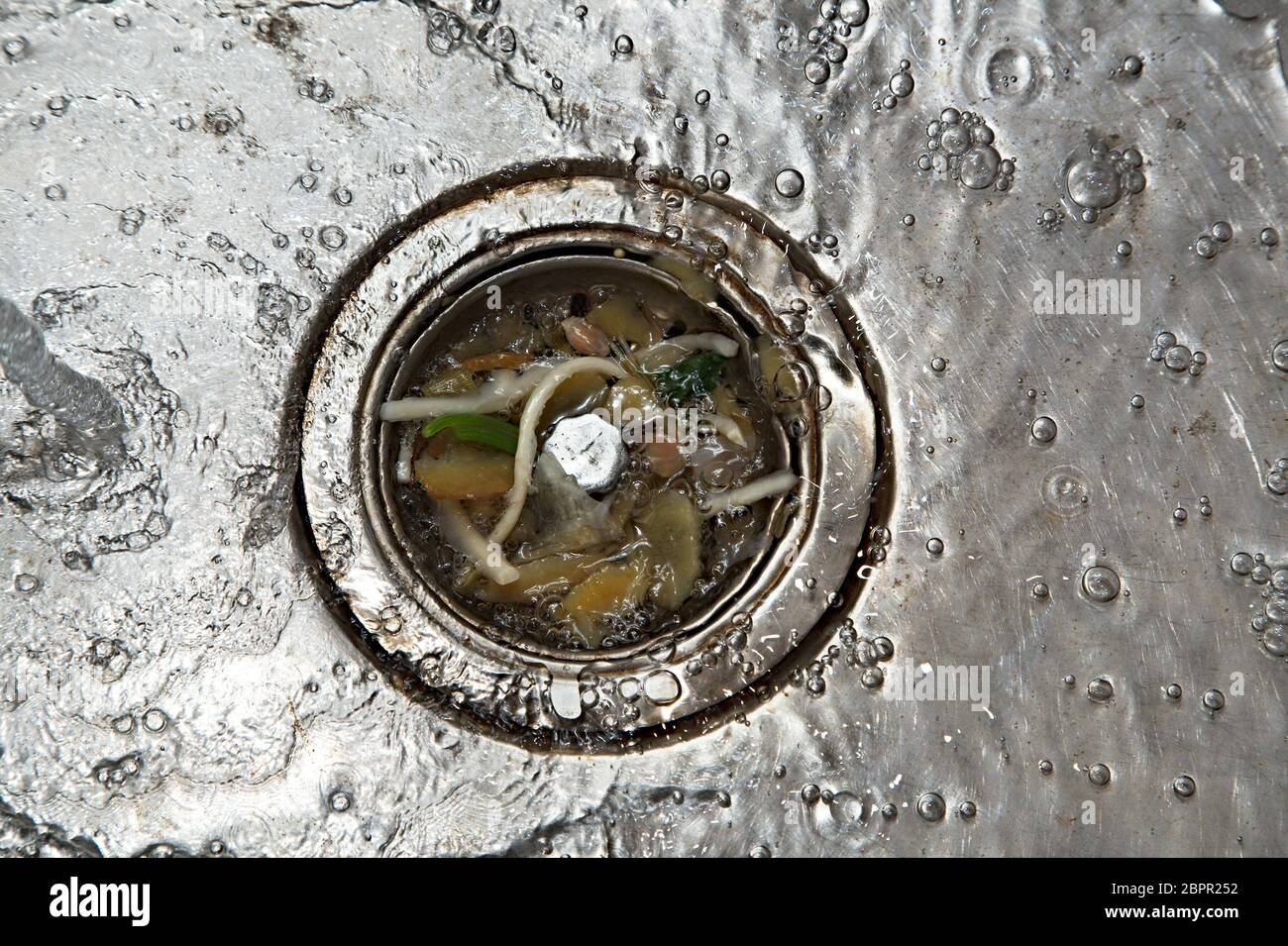Kitchen drain clogging up with food particles Stock Photo Alamy