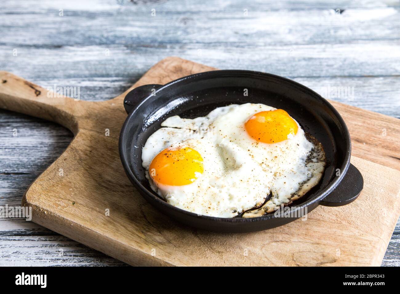 Fried egg. Close up view of the fried egg on a frying pan Stock Photo ...