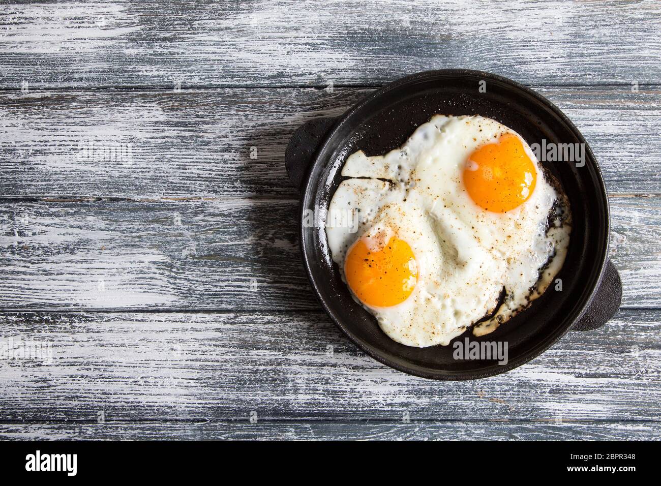 Fried egg. Close up view of the fried egg on a frying pan Stock Photo ...