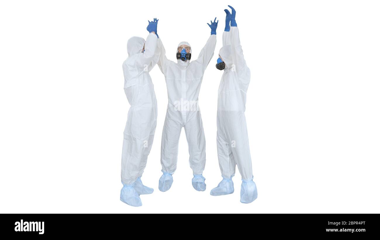 Doctors in hazamat suits stacking hands Team work on white background. Stock Photo