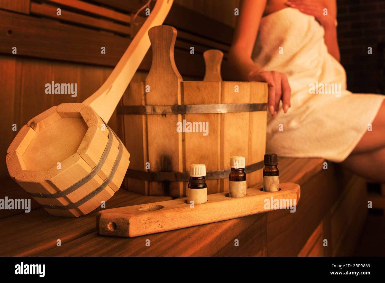 Wooden bath accessories with aromatic oil bottle for bath in the sauna