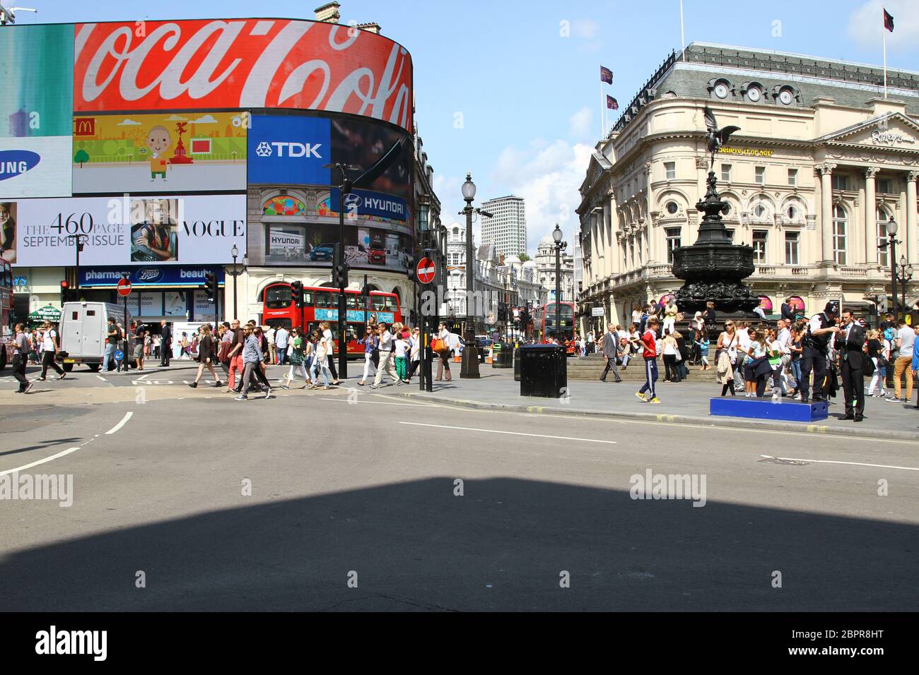 WIDE ANGLE VIEW OF PICADDILLY CIRCUS IN CENTRAL LONDON WITH THE STATUE OF EROS TO THE RIGHT , SHAFTSBURY AVENUE BETWEEN THE TROCADERO AND THE ADVETISING DISPLAY. NO TRAFFIC. COMPANIES ADVERTISING ARE COCA COLA, VOGUE MAGAZINE, TDK, SAMSUNG AND HYUNDAI. Stock Photo