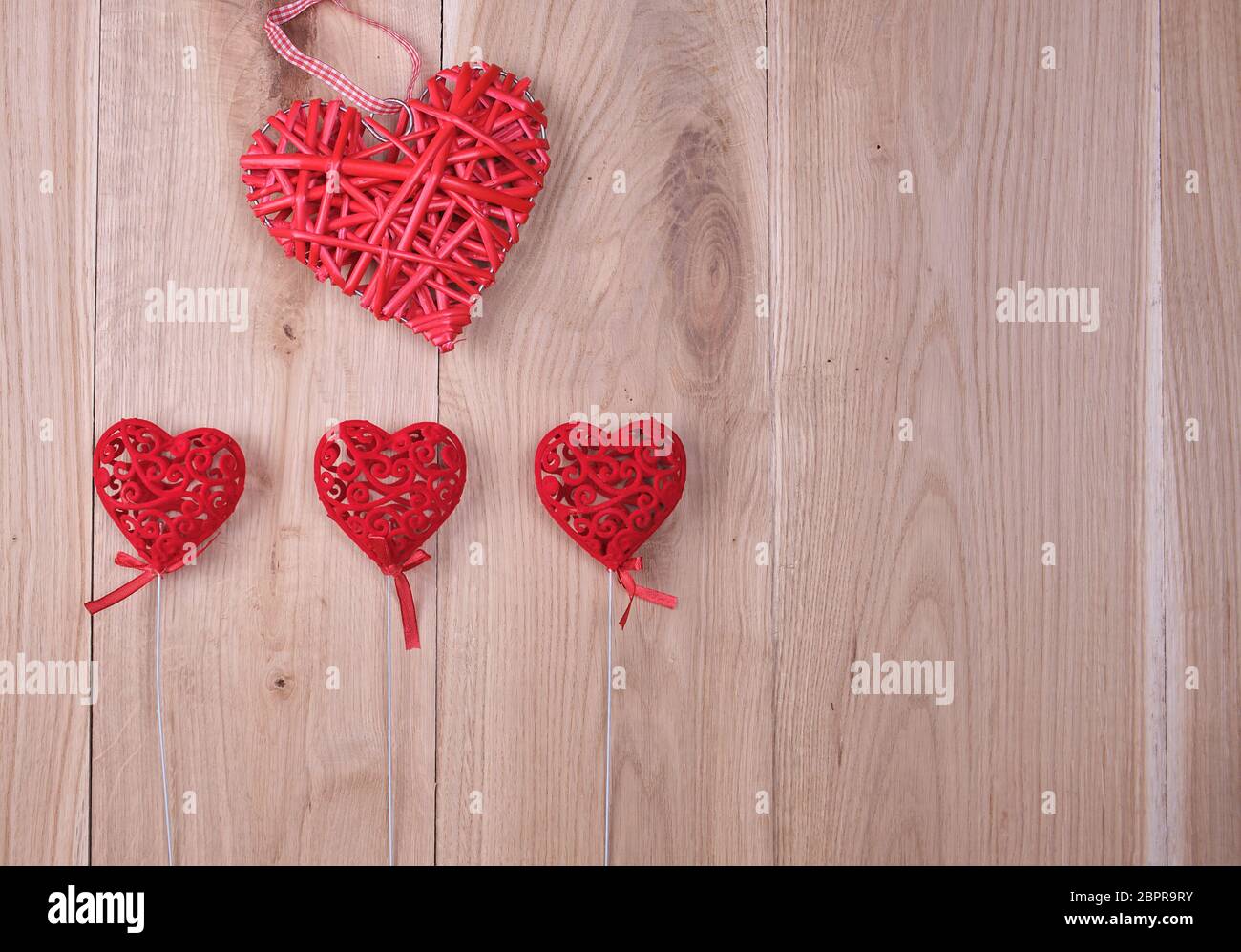 red hearts on a wooden background of oak boards, copy space Stock Photo
