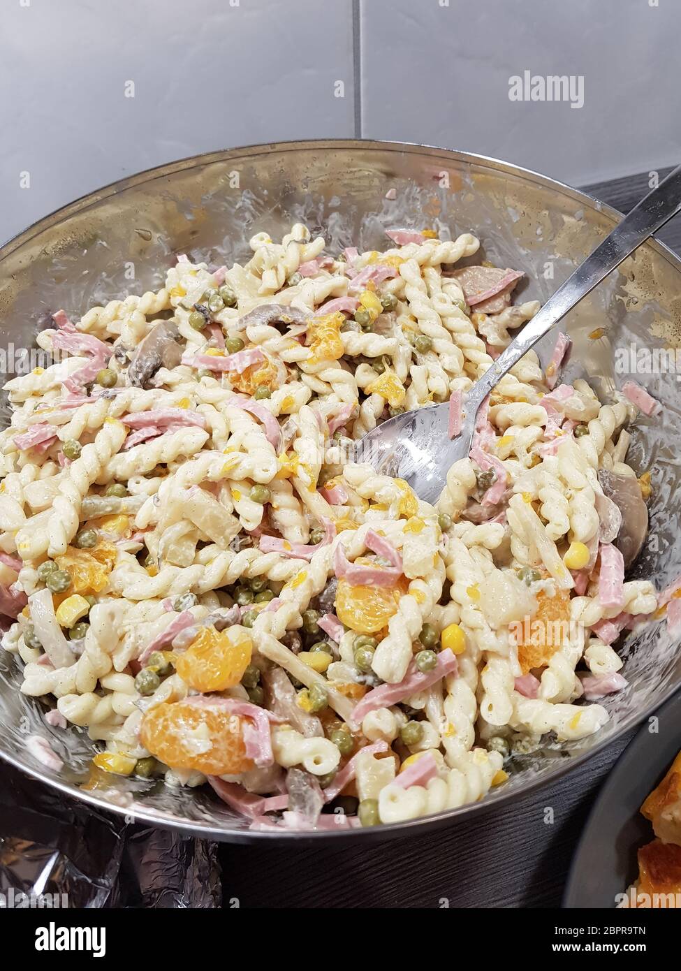Homemade pasta salad with freshly chopped basil and tomatoes Stock Photo