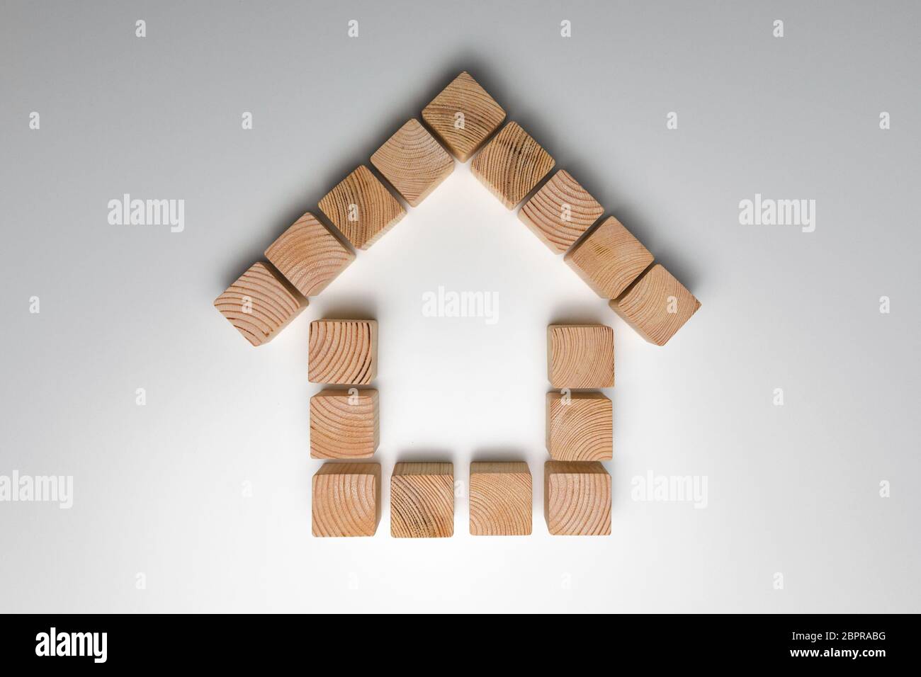 House of natural colored toy blocks on white background. House building concept Stock Photo