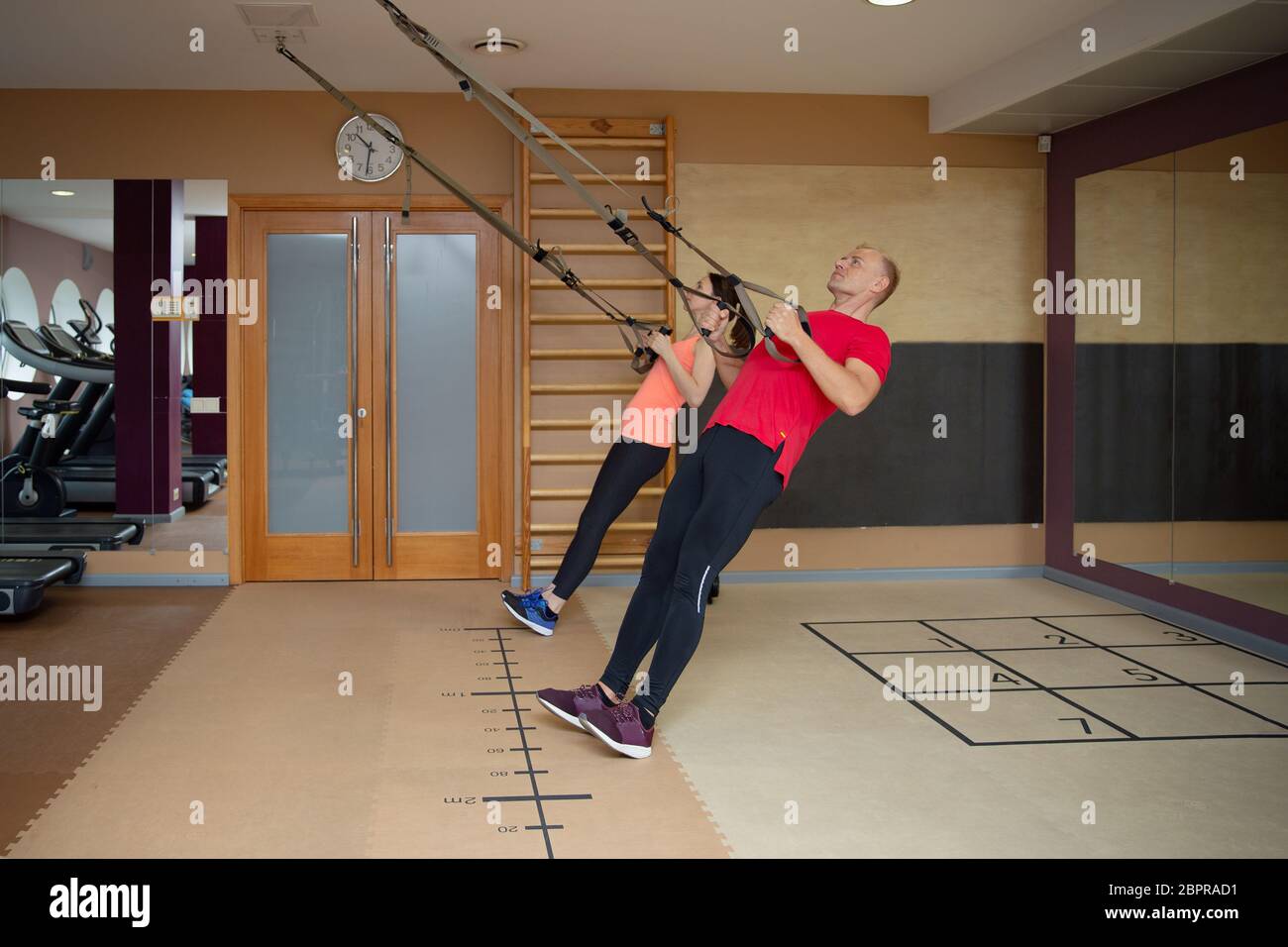 Fitness partners, sports people are working out with TRX in gym. Total body  resistance exercises Stock Photo - Alamy