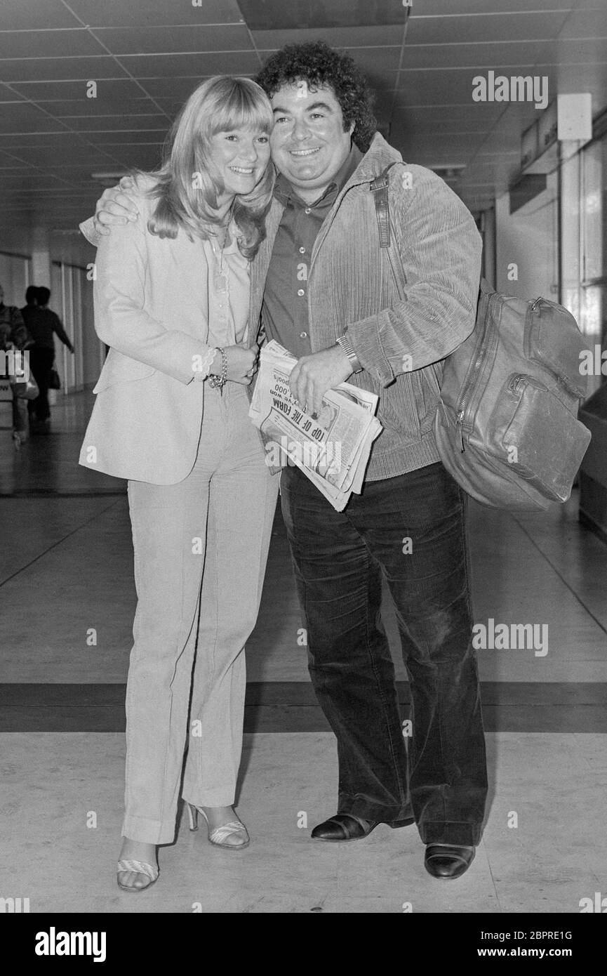 British comedian Eddie Large with his new girlfriend Patsy Anne Scott leaving London's Heathrow Airport in October 1979. Stock Photo
